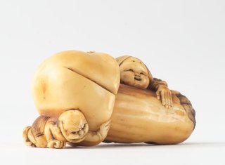 AGNSW collection Netsuke in the form of a mushroom with 'okame' leaning against it and 'oni' crouching under it 19th century