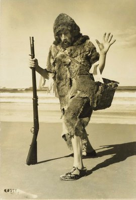 Alternate image of recto: Untitled (woman in hat with peanuts)
verso: Untitled (Robinson Crusoe: man on beach in ‘cave man’ furs) by Max Dupain