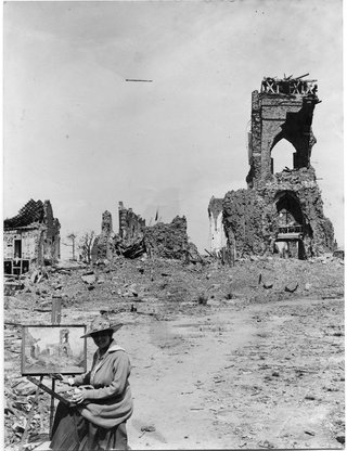 This gelatin silver photograph from the Art Gallery of NSW's National Art Archive, by an unknown photographer, shows Evelyn Chapman, the first Australian female artist to visit the battlefields, painting the ruins of the church at Villers-Bretonneux, France, c1919.